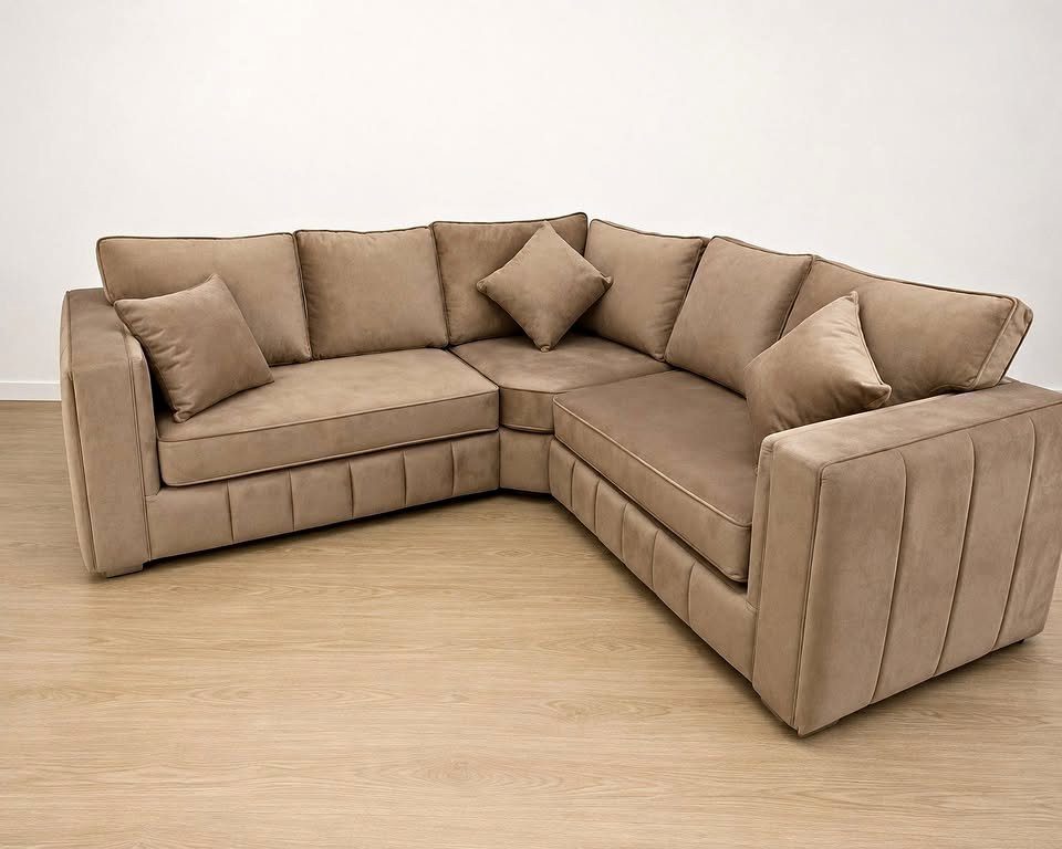 Beige velvet corner sofa on a wooden floor